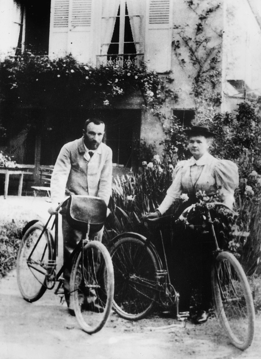 Vintage cycling images of the  French scientist couple Pierre and Marie Curie on their honeeymoon leaning on their bicycles in 1895